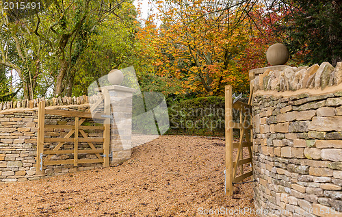 Image of Open wooden gates at entrance to modern house