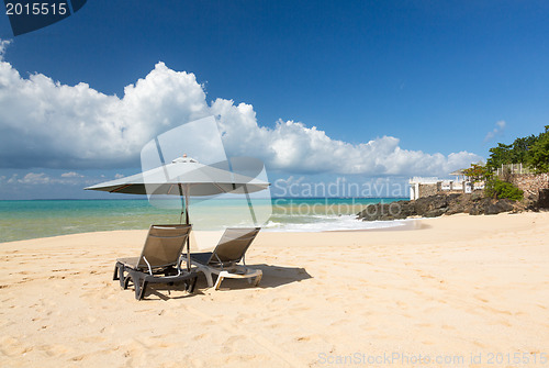 Image of Reclining chairs and umbrella on Baie Rouge