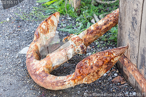 Image of Old rusty anchor on dockside