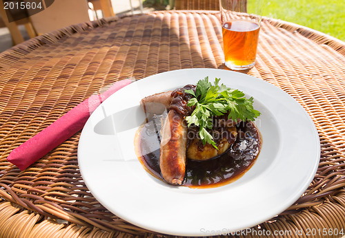 Image of Sausage and mash with gravy in english pub