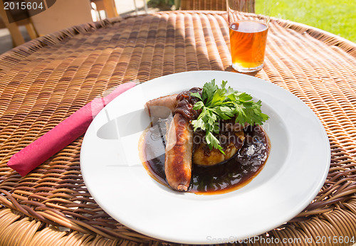 Image of Sausage and mash with gravy in english pub