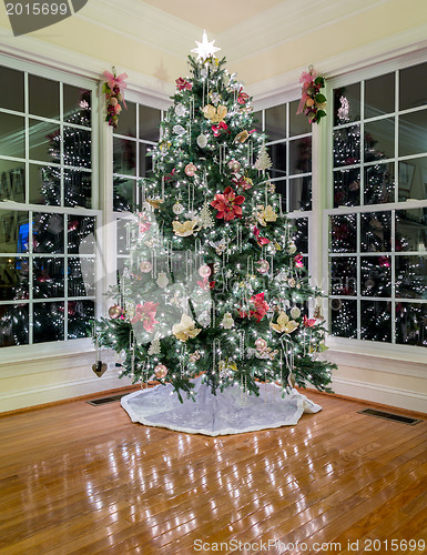Image of Christmas tree at night in modern room