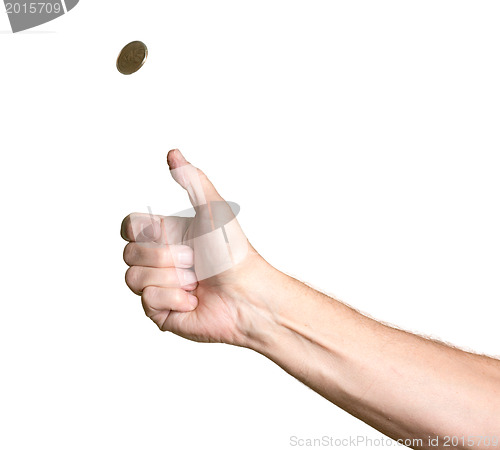 Image of Man's arm and hand tossing golden coin