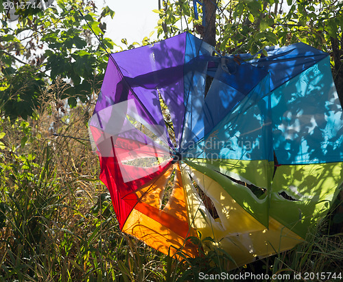 Image of Broken beach umbrella torn by storm