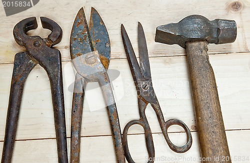 Image of Hammer and nippers on wood background