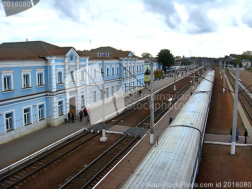 Image of building of railway station and the top of train