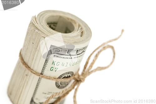 Image of Roll of One Hundred Dollar Bills Tied in Burlap String on White