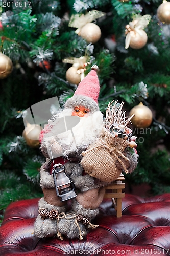 Image of Santa Claus with gifts under a Christmas fir-tree