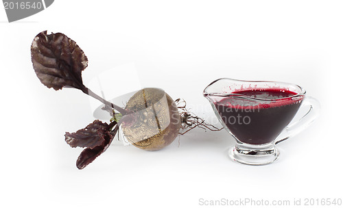 Image of Red beets with leaves and jug with juice