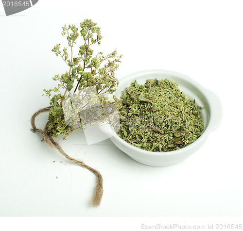 Image of Dried oregano in a bowl and oragano twigs