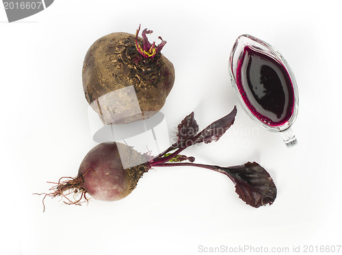 Image of Red beets with leaves and jug with juice