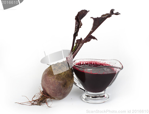 Image of Red beets with leaves and jug with juice
