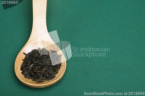 Image of Wild black rice in wooden spoon