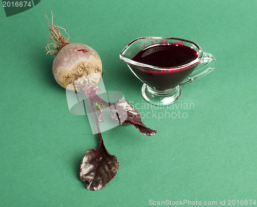 Image of Red beets with leaves and jug with juice