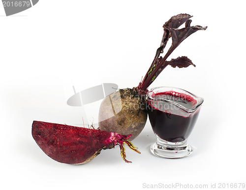 Image of Red beets with leaves, slice beets and jug with juice