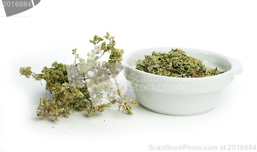 Image of Dried oregano in a bowl and oragano twigs