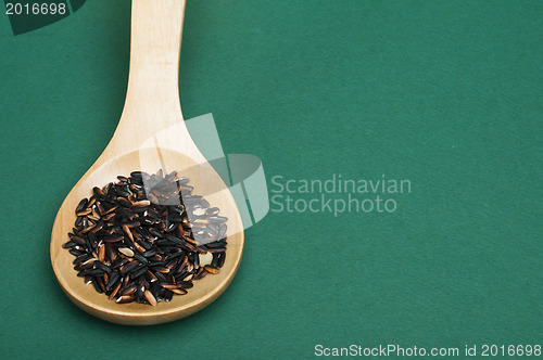 Image of Black rice in wooden spoon