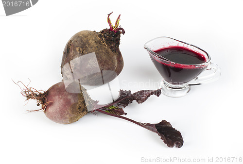 Image of Red beets with leaves and jug with juice