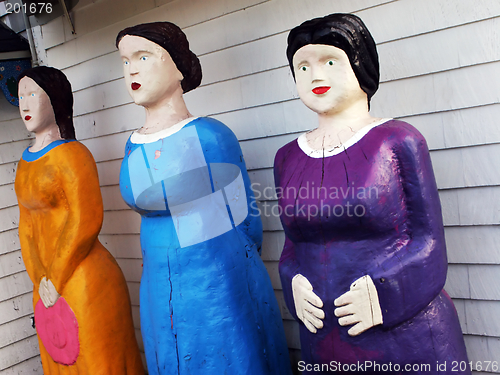 Image of Three female statues in bright clothing