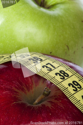 Image of Red and green apple and centimeter