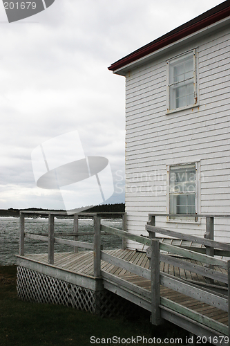 Image of White weather board building overlooking the ocean