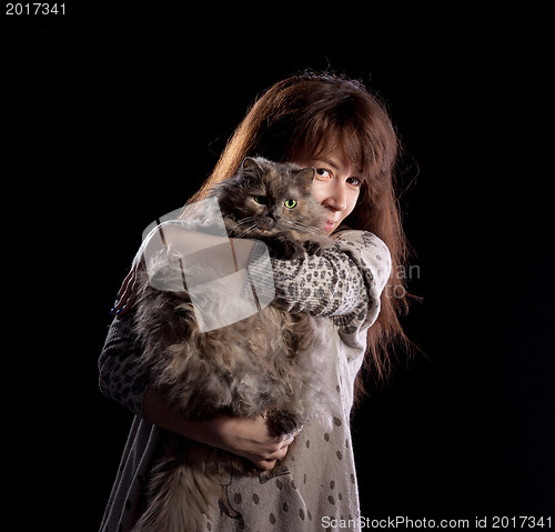 Image of Young beautiful smiling woman holds fluffy cat