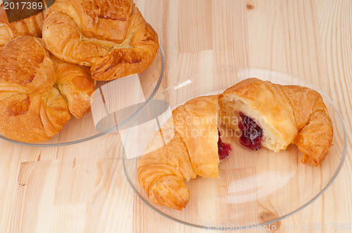 Image of croissant French brioche filled with berries jam