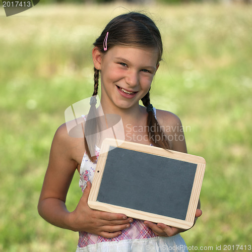 Image of Girl holding a small blackboard