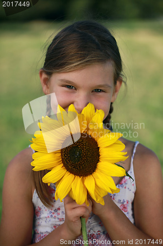 Image of Young girl with a sunflower