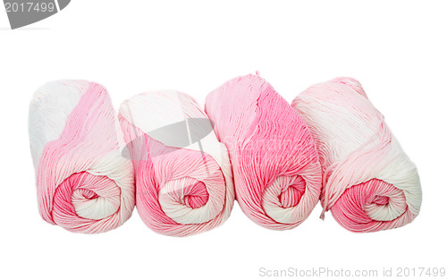 Image of Skeins of white and pink thread.