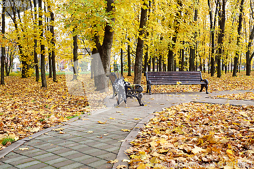 Image of Bench and umbrella on the alley.