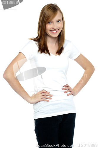 Image of Attractive teenager posing casually, hands on waist