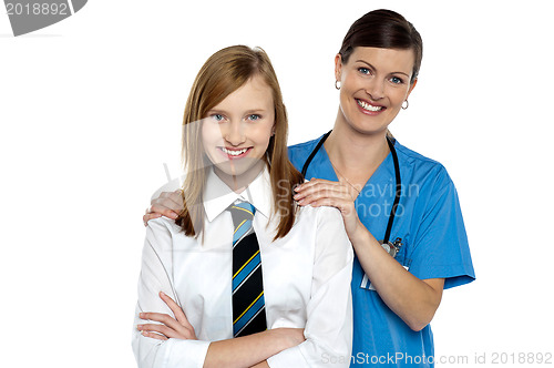 Image of Graceful doctor posing with her teenage patient