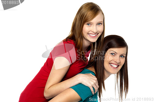 Image of Mother piggybacks her teenage girl