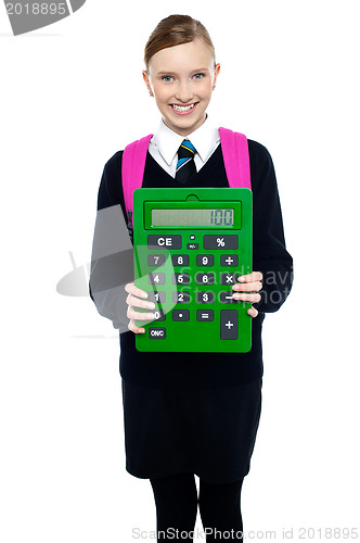 Image of School girl holding large green calculator
