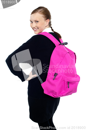 Image of Teen girl turning back and passing smile to you