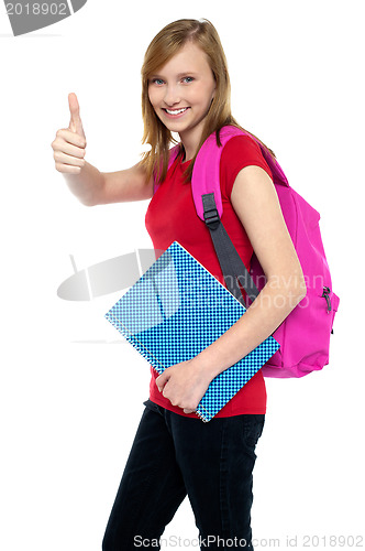 Image of Pretty university student showing thumbs up sign