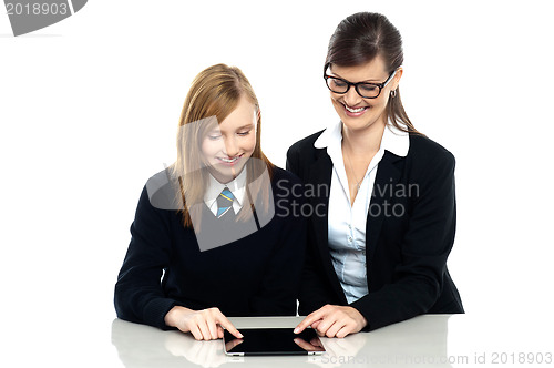 Image of Educator and student exploring a tablet device