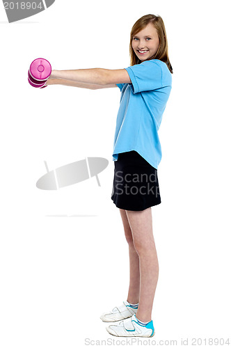 Image of Pretty teen working out with pink dumbbells