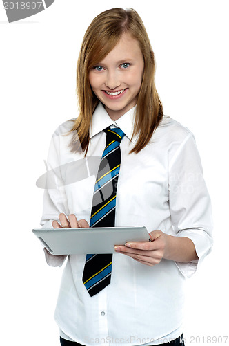 Image of Cheerful student in school attire using tablet pc