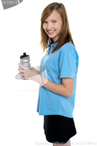 Image of Girl holding sipper bottle. Break from gym workout