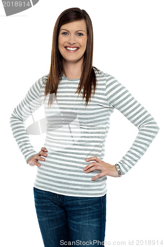 Image of Trendy woman posing with hands on her waist