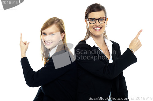 Image of Student with teacher, back to back. Pointing away