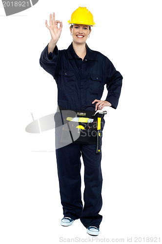 Image of Female worker in jumpsuit showing perfect gesture