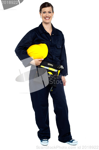 Image of Relaxed construction worker with yellow helmet