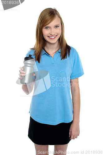 Image of Teen in sports wear posing with a water bottle