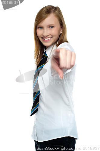 Image of Cheerful young girl pointing towards the camera