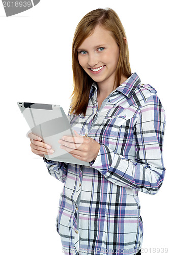 Image of Attractive cute girl holding a tablet device