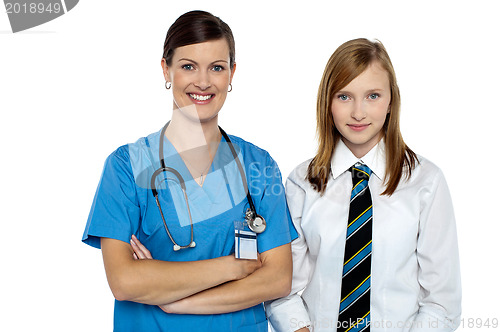 Image of Confident medical expert posing with school girl