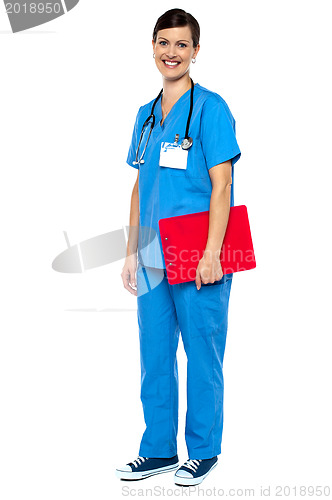 Image of Nurse wearing blue uniform and holding red clipboard